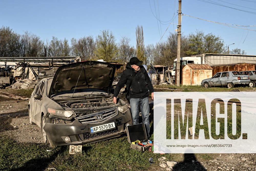 A man stands by a car damaged by a Russian drone strike at a parking lot in Zaporizhzhia, Ukraine, April 15, 2026. The attack killed a 74-year-old woman and damaged the stop, a parking lot, and nearby residential buildings. (Photo by Dmytro Smolienko Ukrinform) Russian strike on Zaporizhzhia kills woman