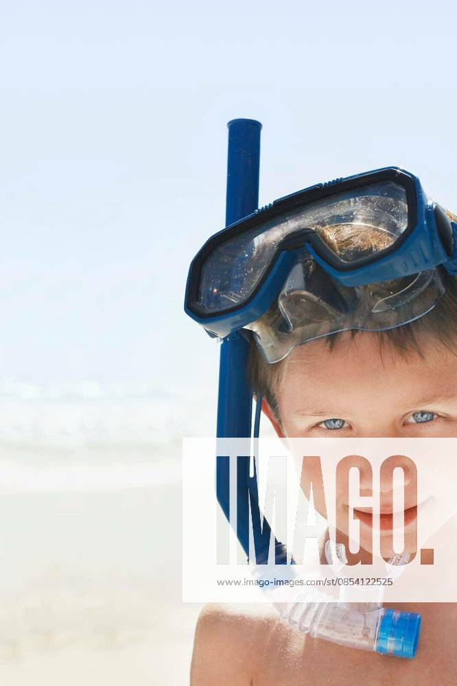 Boy Wearing Snorkeling Goggles On Beach - Closeup portrait of young boy wearing snorkeling goggles on beach model released Symbolfoto