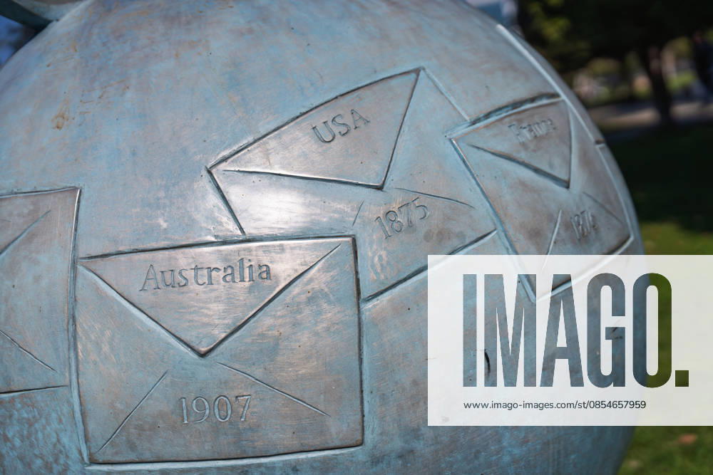 Batumi, georgia 21 april 2026: bronze globe sculpture depicting envelopes and dates representing global post history, creating a symbol for communication and connection Metal globe sculpture showing international communication