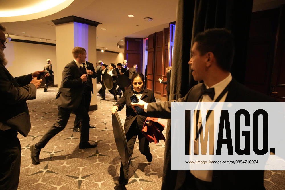 Employees, Secret Service and members of staff flee in the Washington Hilton after shots were heard during the White House Correspondents Dinner in Washington, DC, on April 25, 2026. Shots were fired as President Donald Trump attended a press dinner for the first time as President. WASP20260425121 YurixGripas