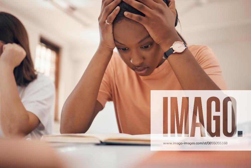 Exam stress, studying and student reading, classroom learning and headache from education. Anxiety, books and African girl with fear of fail on a test, adhd problem and frustrated with school. (License=RF) ,model released, Symbolfoto