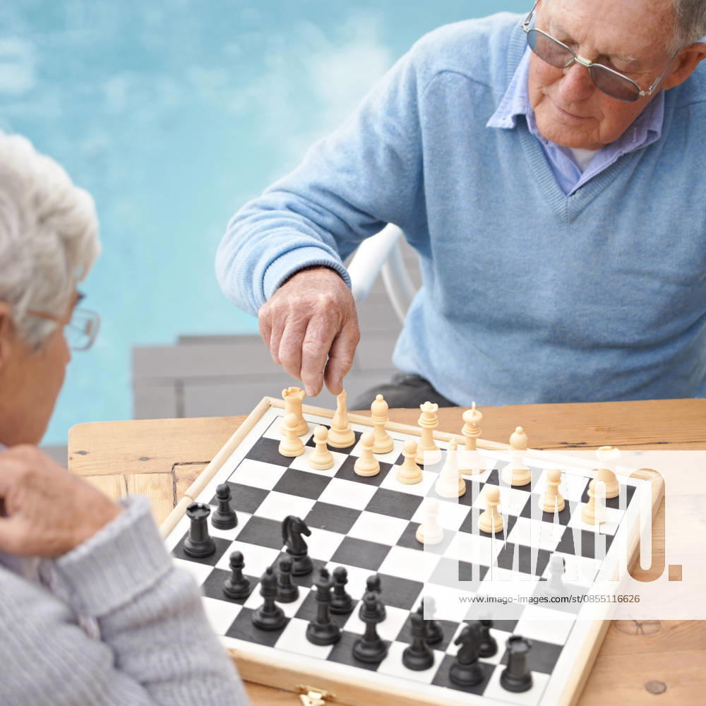 Passing the time with an engrossing game of chess. An elderly couple playing a game of chess (License=RF) ,model released, Symbolfoto