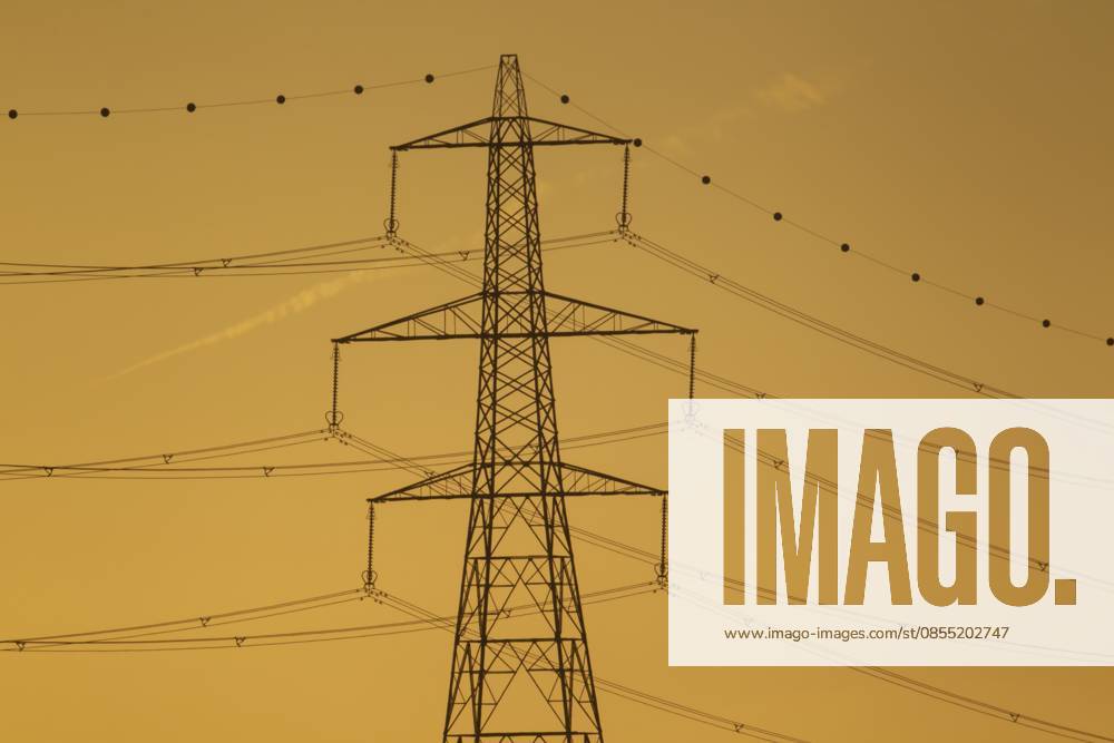 Strommasten und Kabelsilhouette bei Sonnenuntergang, Lincolnshire, England, Großbritannien Electricity power pylon and cables silhouette at sunset, Lincolnshire, England, United Kingdom