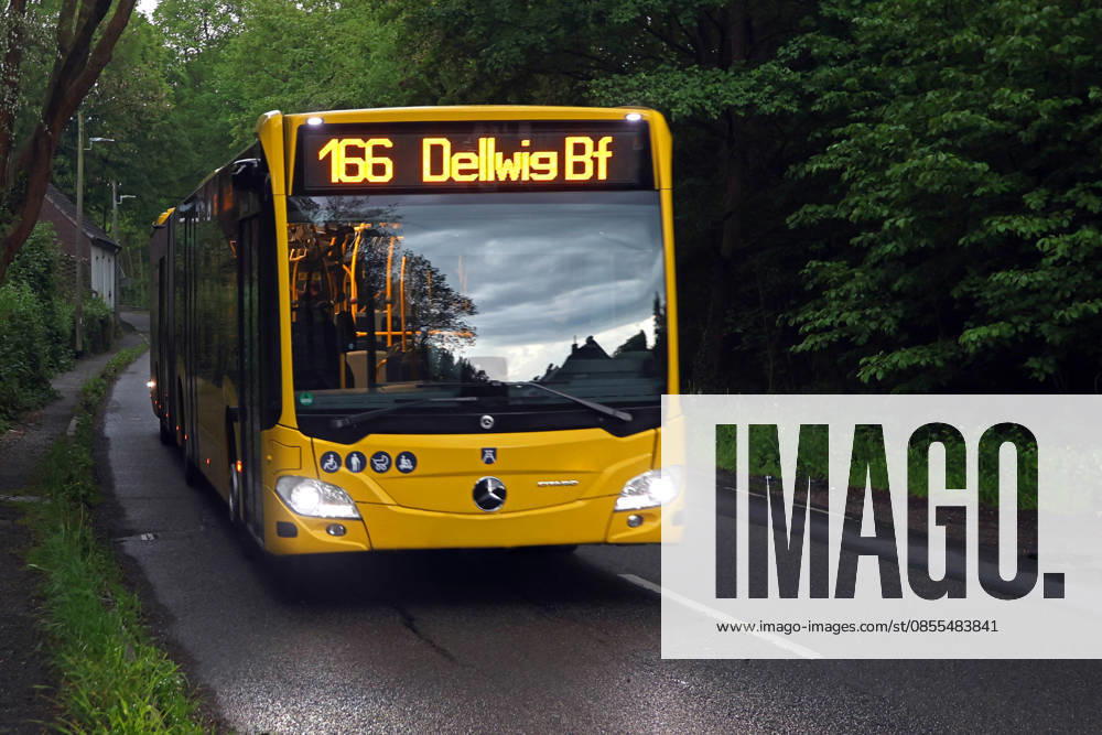 Severe thunderstorms in the city suburbs of Essen during a severe thunderstorm situation and ongoing warning with heavy rainfall from the southwest A public bus is nevertheless on the road for passengers Essen North Rhine-Westphalia Germany