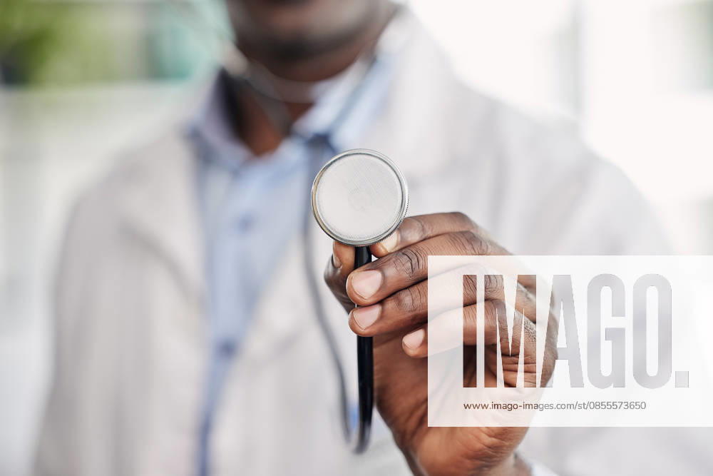 Hand, stethoscope closeup and doctor with help, healthcare service and black man in hospital. African medic, medical tools and close up for health, wellness and listening to heart, breathing and care. (License=RF) ,model released, Symbolfoto