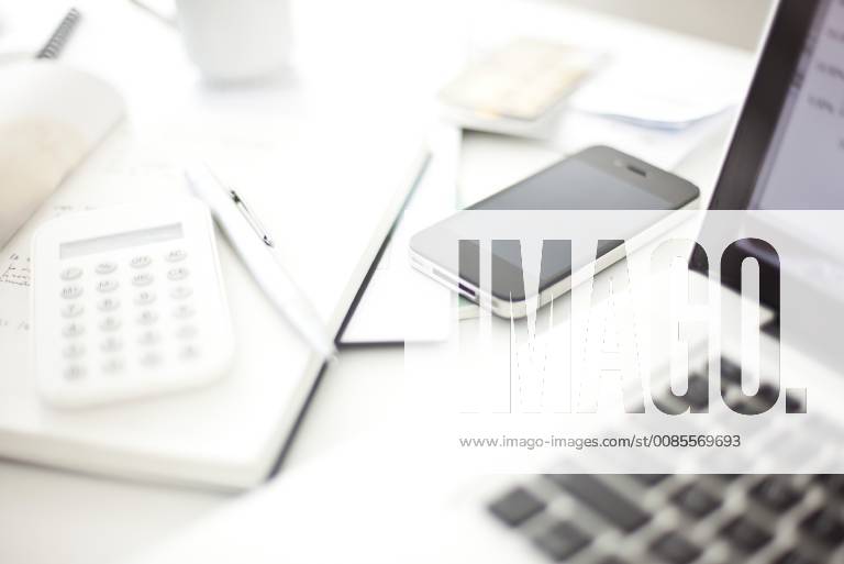 Smartphone resting on desk in in home office