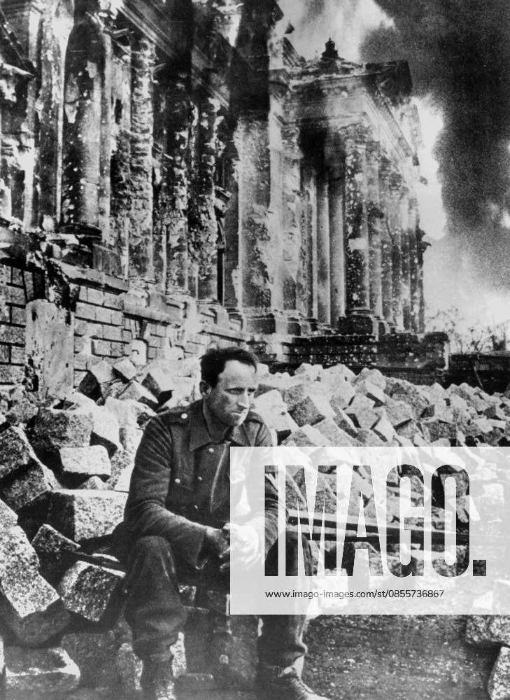 A photograph of a German soldier amidst the ruins of the Reichstag building in Berlin. A photograph of an unidentified German soldier sitting amidst the substantial rubble of the severely damaged Reichstag building in Berlin shortly after the Russian army entered the city, marking the final stages of the Second World War on the European Eastern Front and the defeat of the Third Reich. 1945. Editorial use only. All other uses to be cleared with the copyright owner (World History Archive), in advance., WHA_011_0149.jpg, World War II; Second World War; WWII; 1945; Berlin; Reichstag building; Battle of Berlin; Eastern Front; German soldier; Wehrmacht; Soviet Army; Red Army; Third Reich; Nazi Germany; German defeat; Fall o