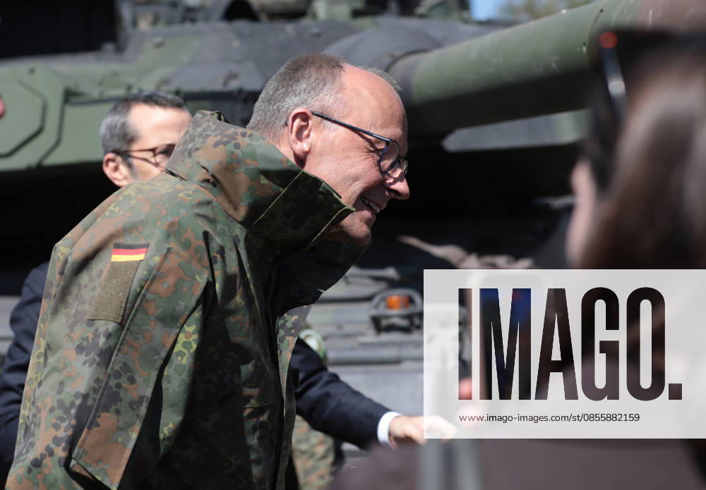 Federal Chancellor Friedrich Merz at the Bundeswehr in Munster He lowers his head in front of a Leopard 2 tank barrel Federal Chancellor Friedrich Merz at the Bundeswehr in Munster He lowers his head in front of a Leopard 2 tank barrel Munster Lower Saxony Germany