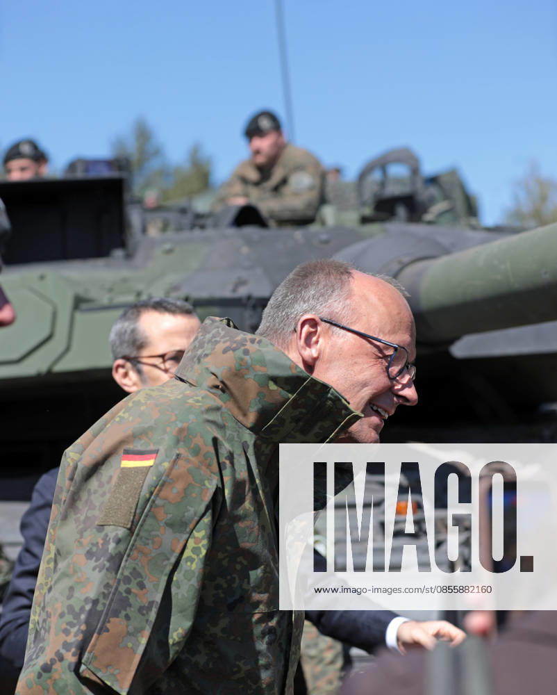 Federal Chancellor Friedrich Merz at the Bundeswehr in Munster He lowers his head in front of a Leopard 2 tank barrel on edge Federal Chancellor Friedrich Merz at the Bundeswehr in Munster He lowers his head in front of a Leopard 2 tank barrel Munster Lower Saxony Germany