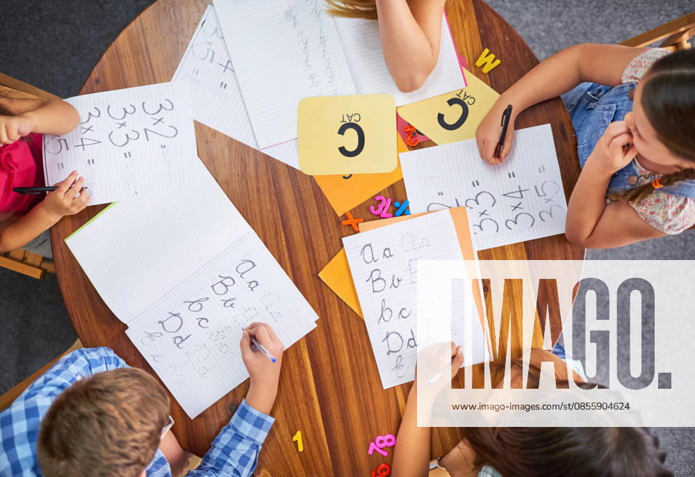 Time to learn something new. High angle shot of a group of unrecognisable young children working in class at school (License=RF) ,model released, Symbolfoto