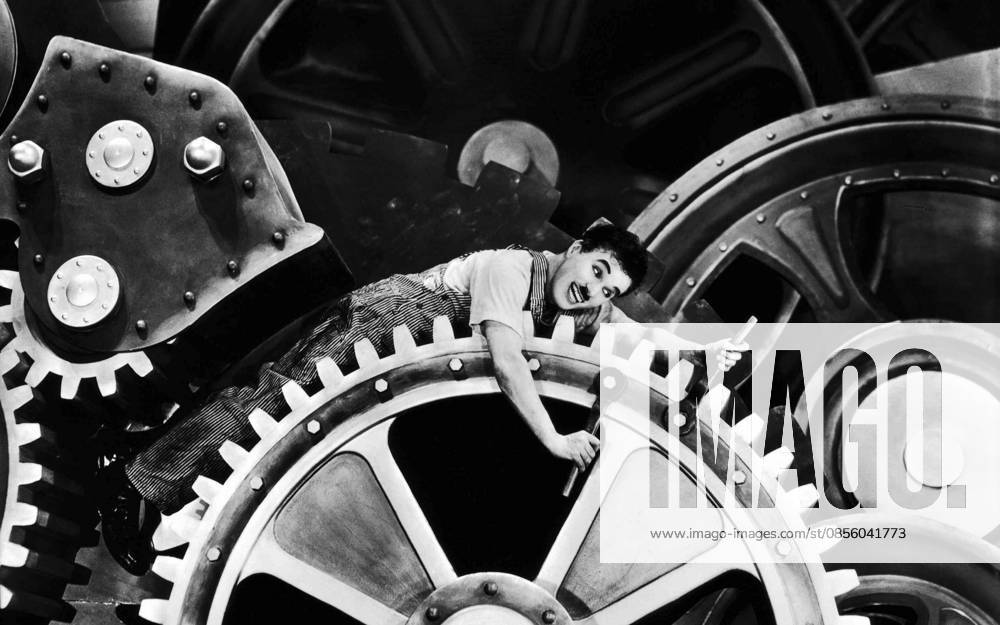 Sir Charles Spencer Charlie Chaplin, KBE (1889-1977) in Modern Times (1936), a grim account of the automatization of the individual Sir Charles Spencer Charlie Chaplin, KBE (1889-1977) in Modern Times (1936), a grim account of the automatization of the individual Editorial use only. All other uses to be cleared with the copyright owner (World History Archive), in advance., WHA_043_0952.jpg, Charlie Chaplin; Modern Times; 1936; silent film; comedy; satire; industrialization; automation; individuality; dehumanization; factory; assembly line; social commentary; iconic; tramp; film star; actor; director; screen legend; black and white; classic cinema; slapstick; social issues; work; society; technology; machinery; hum
