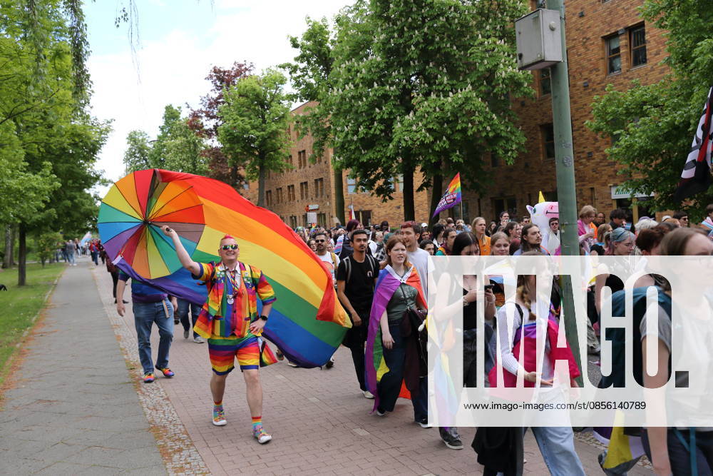 People walk with a rainbow flag in the Pappelallee during a demonstration for Christopher Street Day in Potsdam, May 9, 2026 CSD in Potsdam