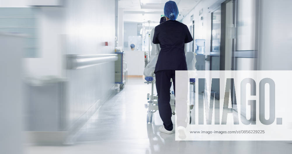 Patient, bed and nurse walking in hospital, hallway or corridor to surgery, operation room or ER healthcare service. Doctor, moving and pushing person in clinic to ICU, bedroom or walk with support. (License=RF) ,model released, Symbolfoto