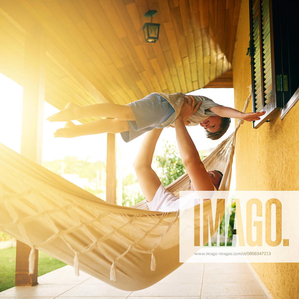 Dad, kid and play on hammock for vacation, airplane and bonding on family holiday. Father, boy child and trust on porch for games, flying fantasy and freedom in summer for happy childhood memories. (License=RF) ,model released, Symbolfoto
