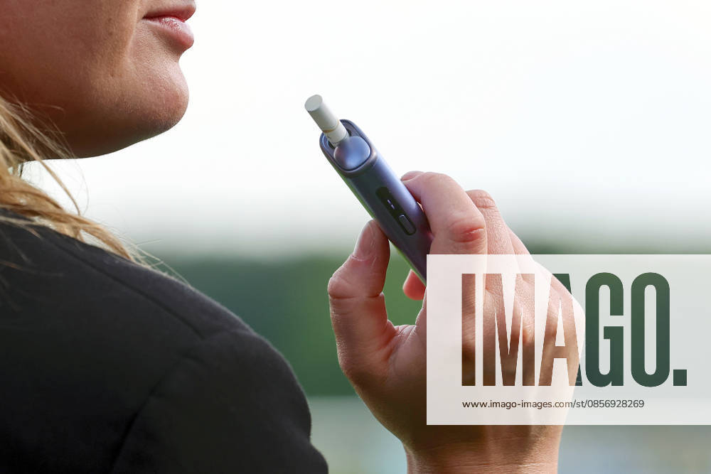 Hoppegarten, Brandenburg, GER E cigarette in one hand crop, exterior, exterior shot, Brandenburg, detail, close-up, German, drug, e vape, e cigarette, electric cigarette, Europe, european, stimulant, hand, Hoppegarten, QF, landscape, addiction, addictive, vape, vaporizer, vaporizer, vaporizer, Western Europe, economy, cigar