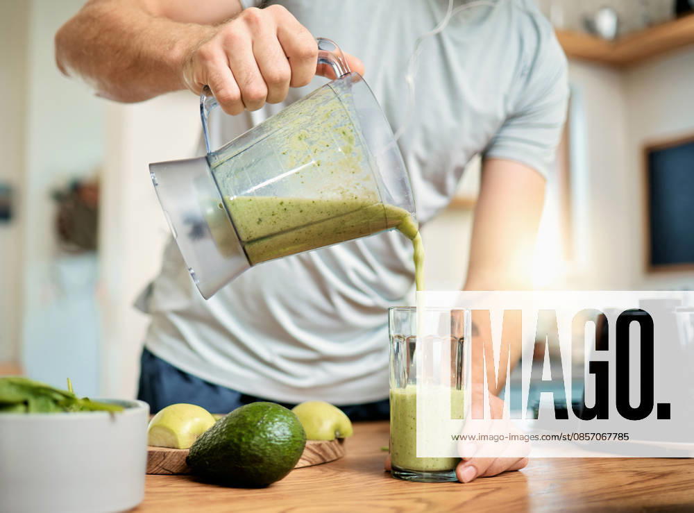Hands, man and pour green smoothie in home for breakfast shake, health benefits and nutrition. Fruit, person and glass with nutrient beverage in blender for detox drink, healthy diet and weight loss. model released property released