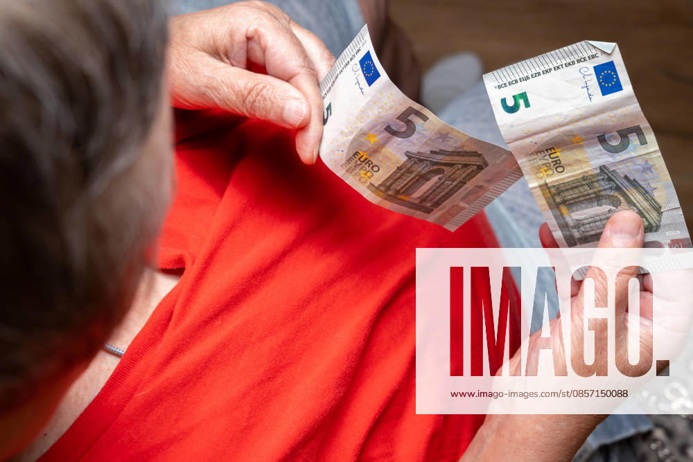 Bavaria, Germany May 20, 2026: An elderly woman of substantial build counts a few euro bills in her hands. The image symbolizes financial insecurity, poverty in old age, and the daily struggle with rising prices and a meager pension.