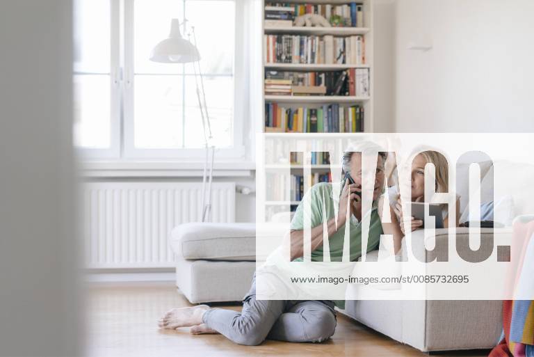 Mature couple at home using cell phone and tablet model released Symbolfoto property released JOSF02446