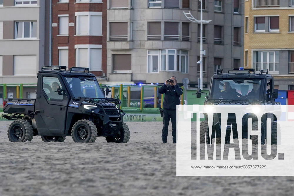 Dunkirk, France. Riot control police (CRS) watch on as migrants board an inflatable boat at the beach at Dunkirk, while attempting to cross the English Channel. More than 200,000 migrants have crossed the Channel in small boats since 2018. Dunkirk France - ZUMAl94_ 20260523_zaf_l94_021