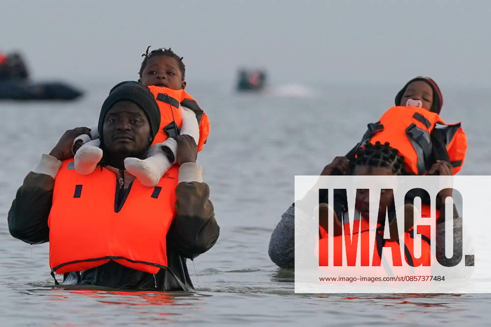 Dunkirk, France. A family of migrants in the sea after failing to board an inflatable boat at the beach at Dunkirk, while attempting to cross the English Channel. More than 200,000 migrants have crossed the Channel in small boats since 2018. Dunkirk France - ZUMAl94_ 20260523_zaf_l94_039
