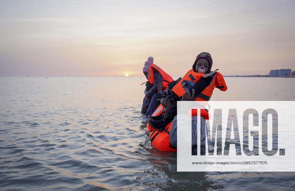 Dunkirk, France. A family of migrants in the sea after failing to board an inflatable boat at the beach at Dunkirk, while attempting to cross the English Channel. More than 200,000 migrants have crossed the Channel in small boats since 2018. Dunkirk France - ZUMAl94_ 20260523_zaf_l94_058