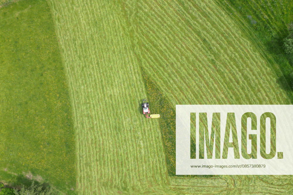 Aerial view spring spring in Siegerland A lush green meadow is mowed by a tractor with a mower mower near Siegen Oberschelden spring spring in Siegerland on 23 05 2026 in Siegen Germany