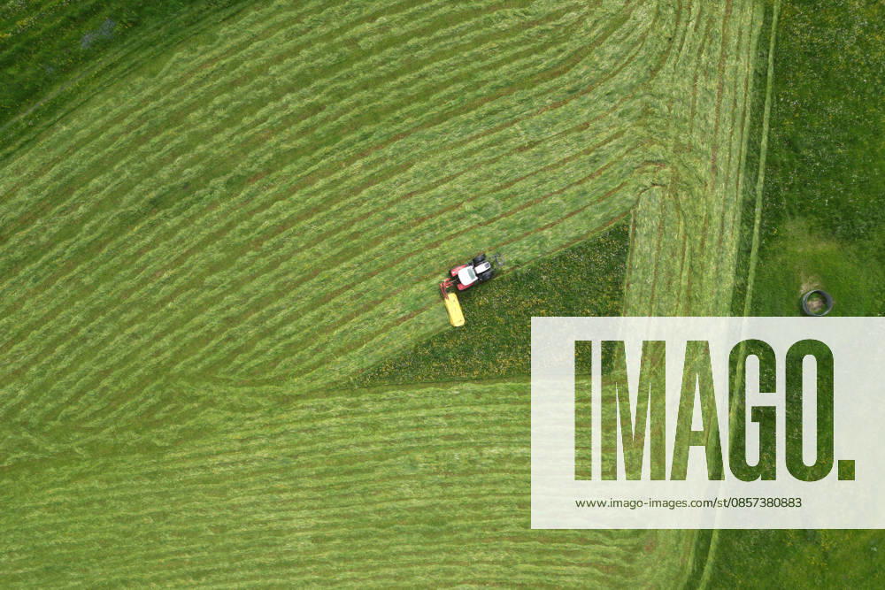 Aerial view spring spring in Siegerland A lush green meadow is mowed by a tractor with a mower mower near Siegen Oberschelden spring spring in Siegerland on 23 05 2026 in Siegen Germany
