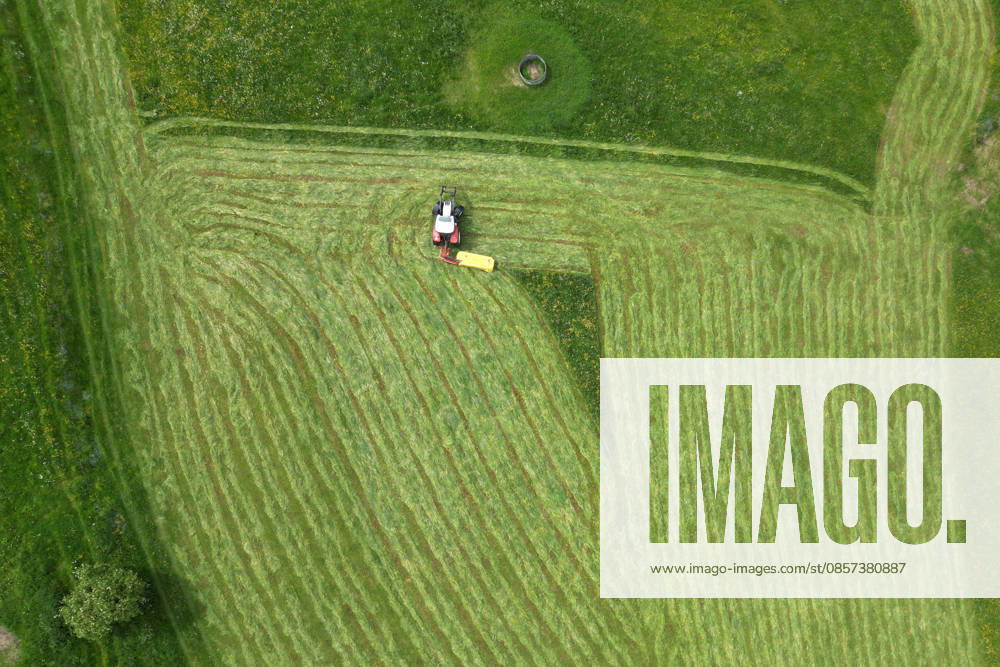 Aerial view spring spring in Siegerland A lush green meadow is mowed by a tractor with a mower mower near Siegen Oberschelden spring spring in Siegerland on 23 05 2026 in Siegen Germany