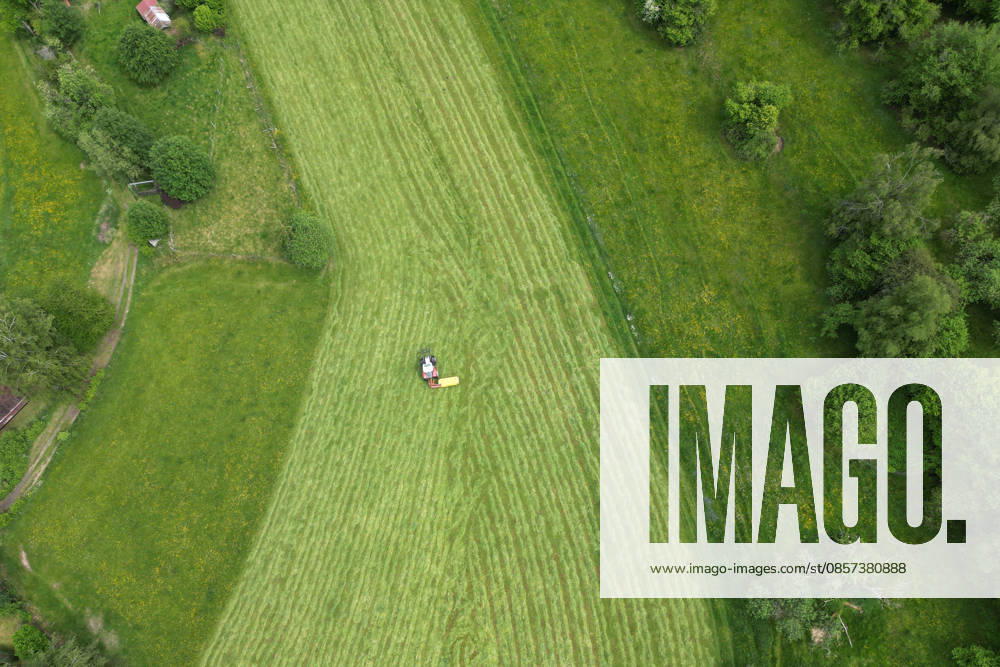 Aerial view spring spring in Siegerland A lush green meadow is mowed by a tractor with a mower mower near Siegen Oberschelden spring spring in Siegerland on 23 05 2026 in Siegen Germany