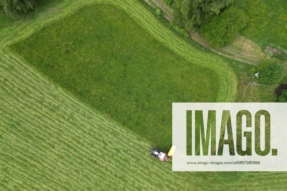 Aerial view spring spring in Siegerland A lush green meadow is mowed by a tractor with a mower mower near Siegen Oberschelden spring spring in Siegerland on 23 05 2026 in Siegen Germany