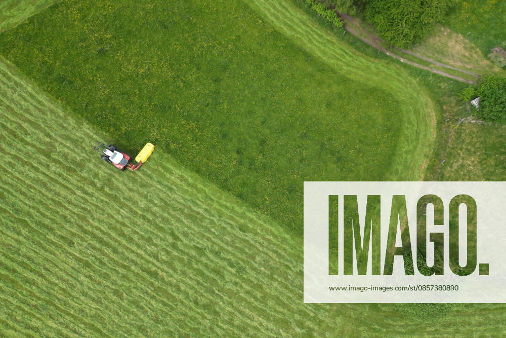 Aerial view spring spring in Siegerland A lush green meadow is mowed by a tractor with a mower mower near Siegen Oberschelden spring spring in Siegerland on 23 05 2026 in Siegen Germany