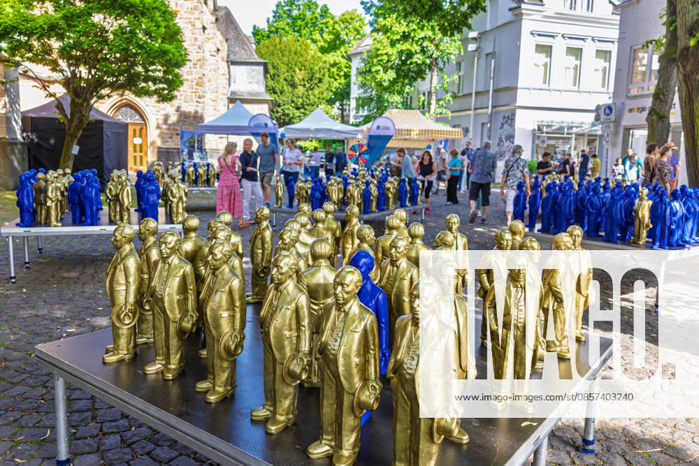 Adenauer art installation in Bad Honnef 23 05 26 Art installation by artist Ottmar Hörl with 200 gold and blue sculptures of the first Federal Chancellor Konrad Adenauer on the church square in Bad Honnef The presentat