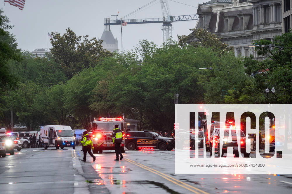 Emergency vehicles crowd the intersection where a gunman fired a volley of shots near the White House before being shot and fatally wounded by U.S. Secret Service police officers. Another person was also injured, according to law enforcement officials. Tower cranes in the background are in use building a new White House ballroom under the direction of President Trump. Washington, DC, May 23, 2026. Photo: Zuma Press Washington USA - ZUMAmj3_ 20260523_zaf_mj3_006