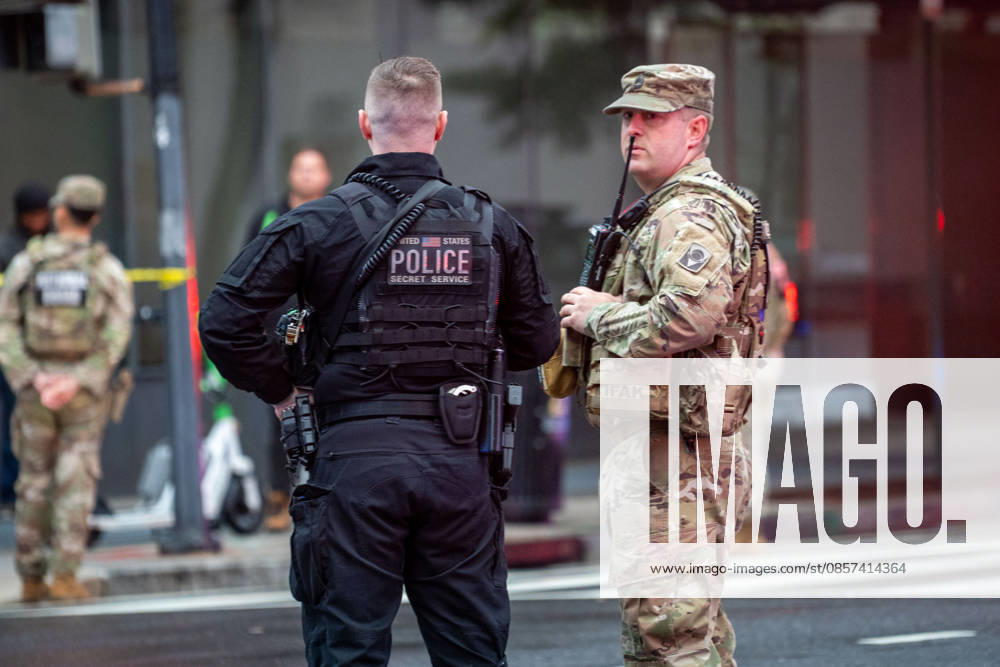 A Secret Service officer and a National Guardsman stand together near the scene where a gunman fired a volley of shots by the White House before being shot and fatally wounded by U.S. Secret Service police officers. Aanother person was injured, according to law enforcement officials. Washington, DC, May 23, 2026. Photo: Zuma Press Washington USA - ZUMAmj3_ 20260523_zaf_mj3_002