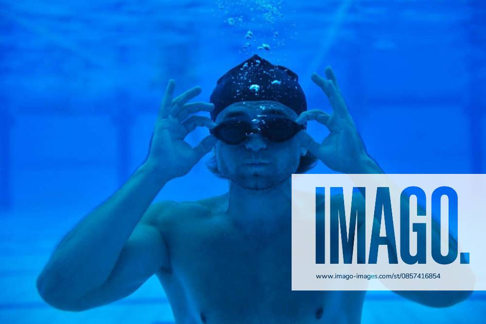 Undervater shoot of swimming pool with good looking young swimmer model released Symbolfoto