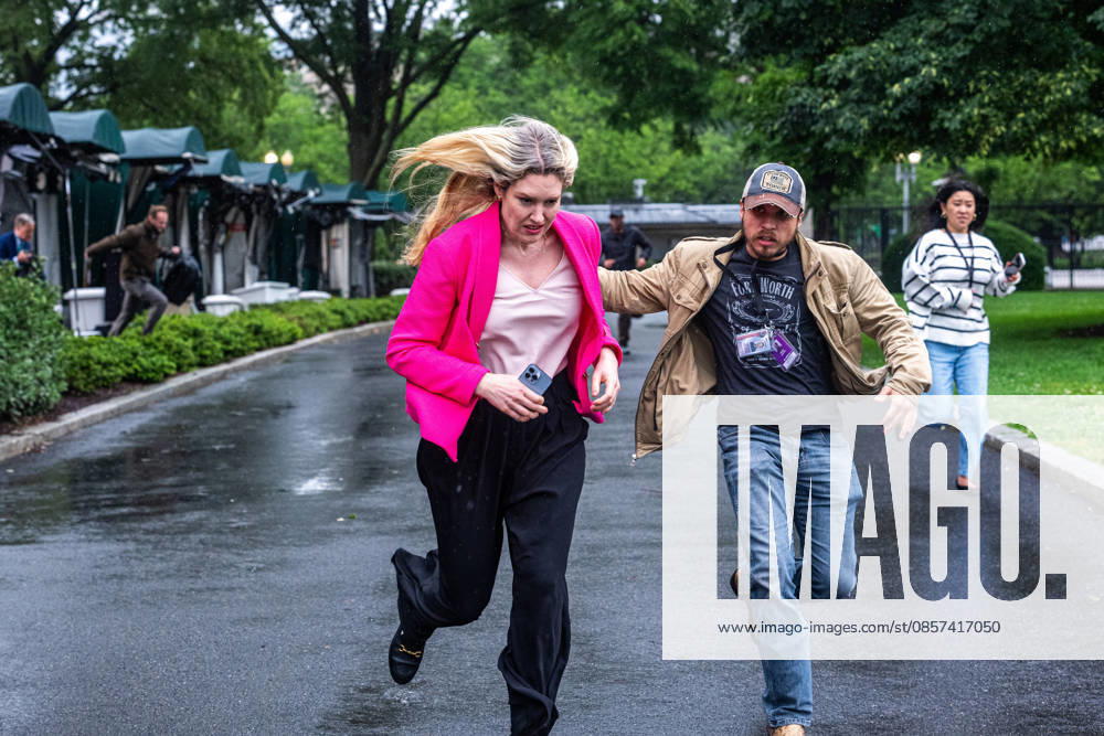 Reporters run for cover following reports of alleged gun fire near the White House in Washington, DC on Saturday, May 23, 2026. A man was shot by US Secret Service agents near the White House on Saturday after he opened fire with a handgun, according to a person familiar with the matter. WASP20260523119 AaronxSchwartz
