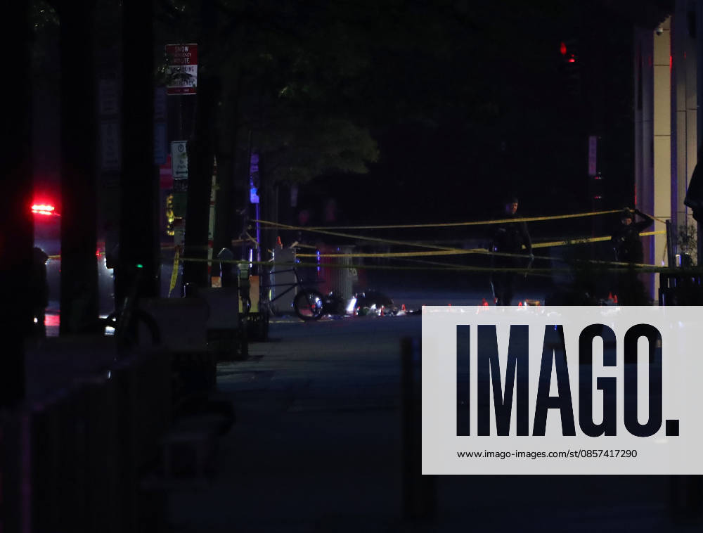 Forensic investigators take photos behind a police tape blocking off a crime scene with evidence markers seen on a sidewalk on 17th and Pennsylvania Ave near the White House in Washington, DC, USA on May 23, 2026. Police and security forces swarmed the area around the White House on the evening of May 23 after reports of shots fired. Washington USA - ZUMAs337 20260523_znp_s337_004