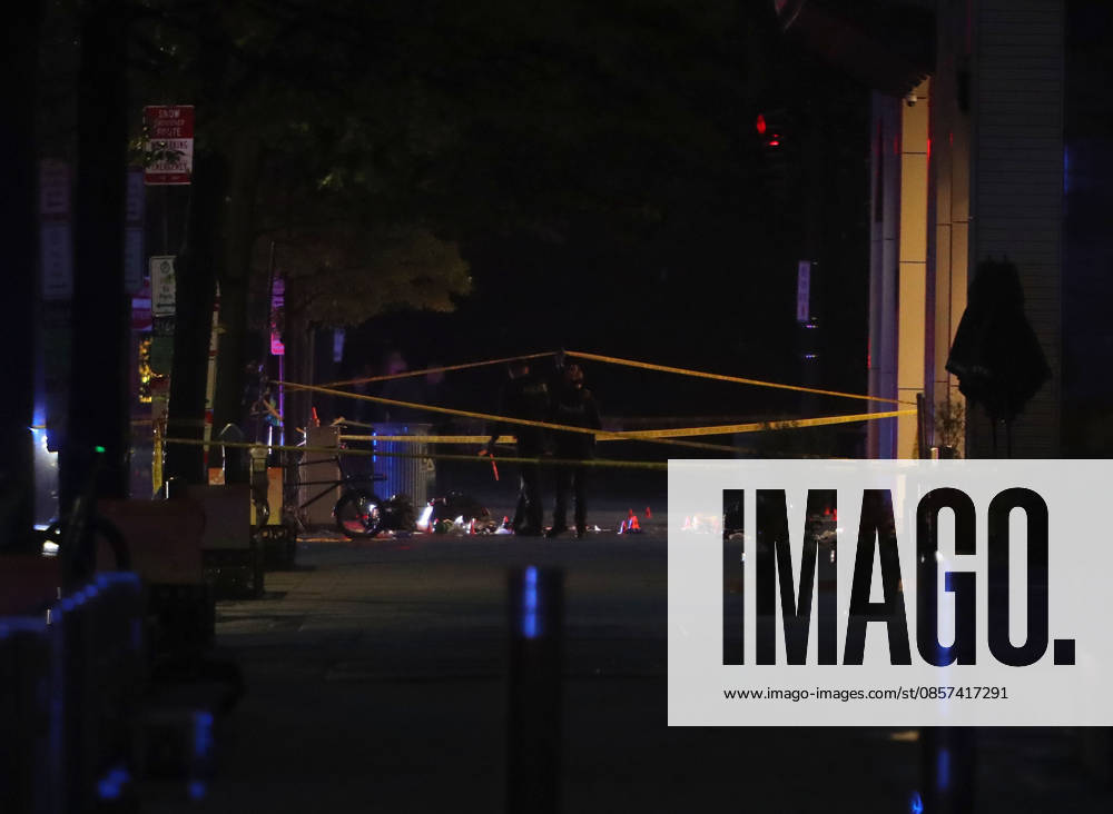 Forensic investigators take photos behind a police tape blocking off a crime scene with evidence markers seen on a sidewalk on 17th and Pennsylvania Ave near the White House in Washington, DC, USA on May 23, 2026. Police and security forces swarmed the area around the White House on the evening of May 23 after reports of shots fired. Washington USA - ZUMAs337 20260523_znp_s337_005