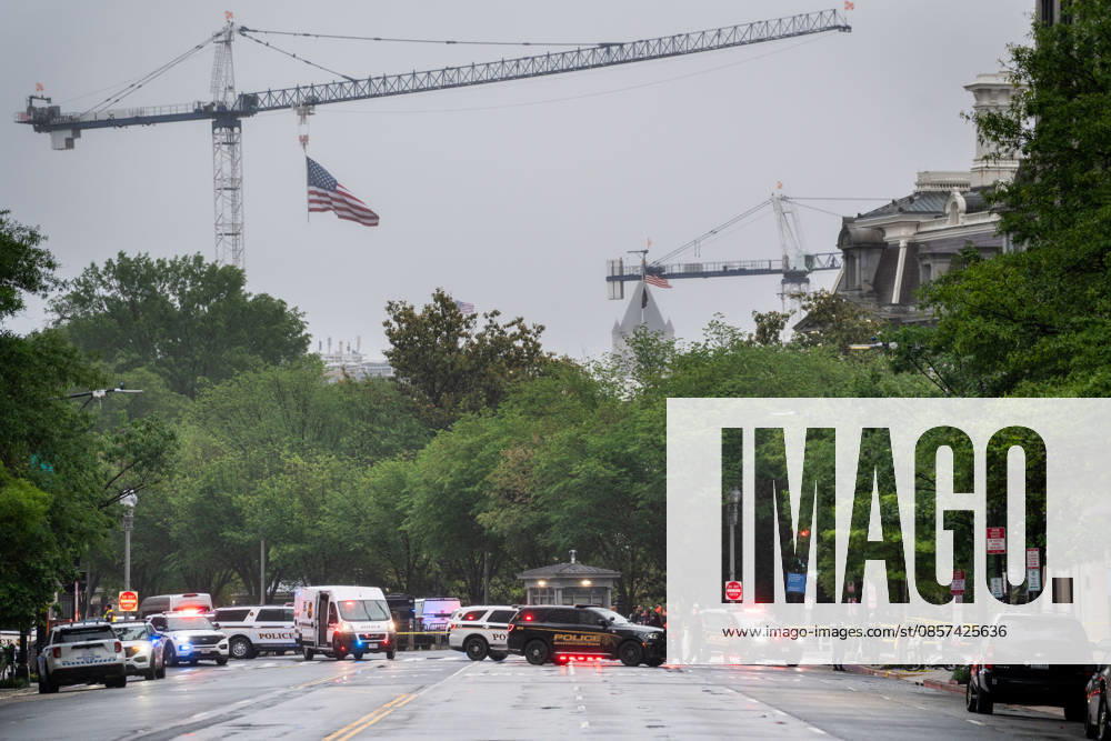 Emergency vehicles crowd the intersection where a gunman fired a volley of shots near the White House before being shot and fatally wounded by U.S. Secret Service police officers. Another person was also injured, according to law enforcement officials. Tower cranes in the background are in use building a new White House ballroom under the direction of President Trump. Washington, DC, May 23, 2026. Photo: Zuma Press Washington USA - ZUMAmj3_ 20260523_zaf_mj3_003