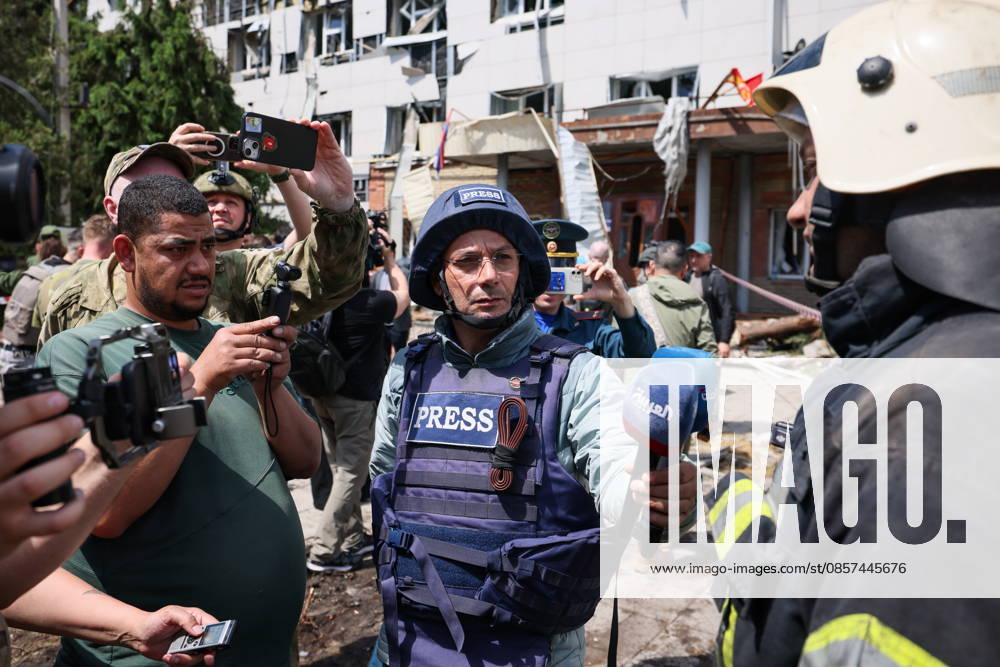 RUSSIA, LUGANSK PEOPLE S REPUBLIC - MAY 24, 2026: Foreign journalists interview an emergency worker at the scene of the May 22 Ukrainian drone strike on the main building and dormitory of the Starobelsk Professional Collage under the Lugansk State Pedagogical University in Starobelsk, north of Lugansk. Out of 86 children aged 14 to 18 inside at the time of the strike, the latest figures indicate 21 dead and 42 injured. Alexander Reka TASS 92975097