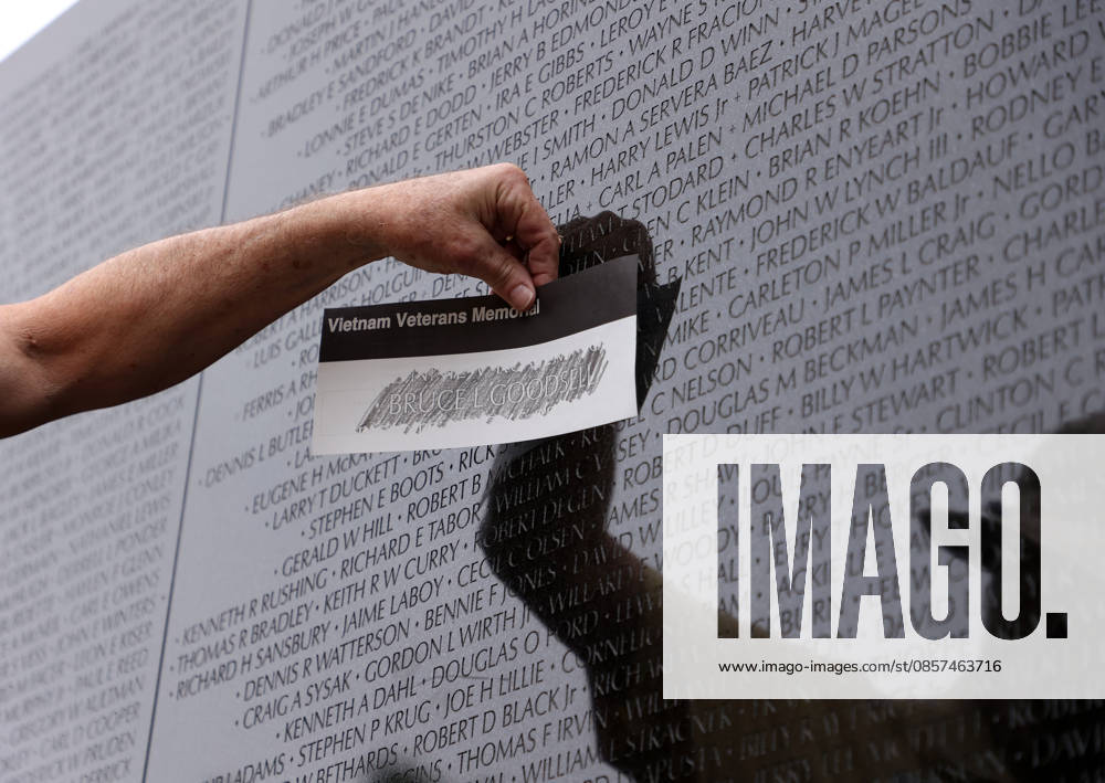 A volunteer sketches in the name of a fallen service member at the Vietnam Veterans Memorial following the Rolling to Remember ride over Memorial Day weekend in Washington, DC, USA, on May 24, 2026. The Rolling to Remember tradition has been active for 38 years, honouring fallen service members, prisoners of war, and those still missing in action during Memorial Day weekend. Washington USA - ZUMAs337 20260524_znp_s337_051