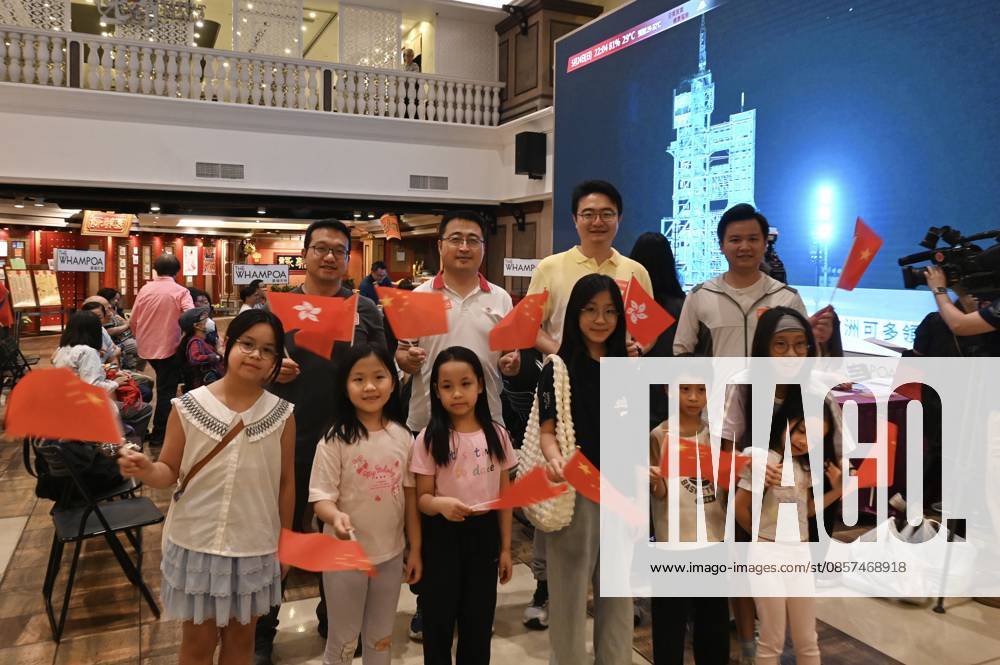 Local residents watch the live broadcast of the launch of the Shenzhou-23 crewed spacecraft at a shopping mall on May 24, 2026 in Hong Kong, China. A Long March-2F rocket carrying the Shenzhou-23 spacecraft with three Chinese astronauts Zhu Yangzhu, Zhang Zhiyuan, Li Jiaying (or Lai Ka-ying) on board blasts off from the Jiuquan Satellite Launch Center in northwest China.