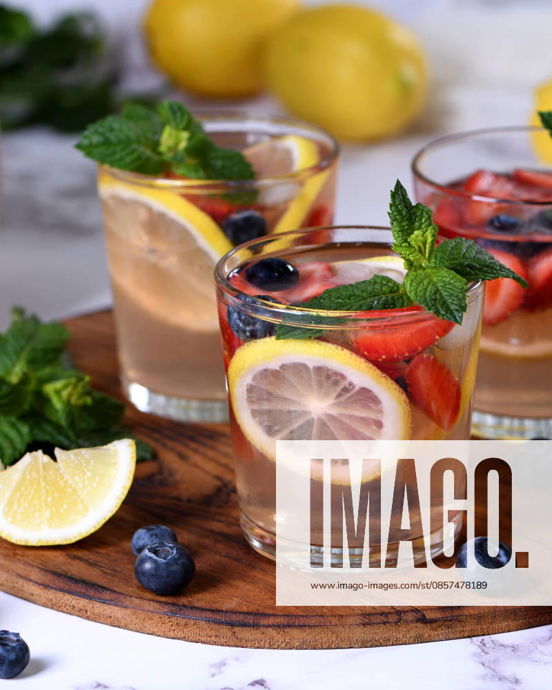 Frische Sommerlimonade mit Beeren und Minze im Glas auf einem Holzbrett. Frische Sommerlimonade mit Beeren und Minze im Glas auf einem Holzbrett. (License=RF)