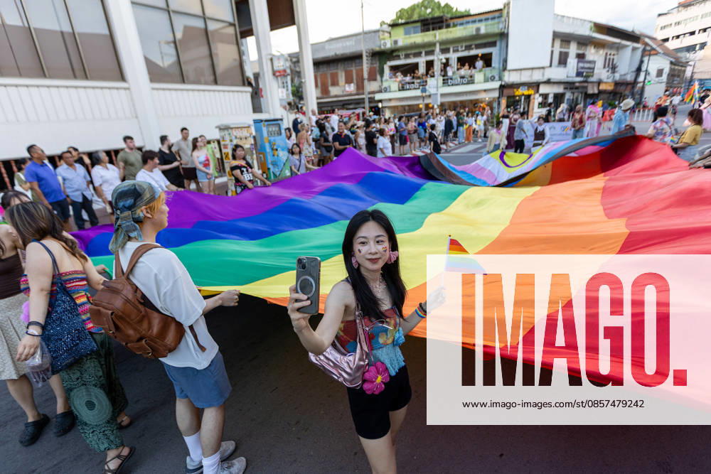 A participant holds a rainbow flag and takes a selfie during The Chiang Mai Pride Parade 2026 celebrations. The Chiang Mai Pride Parade 2026 took place in Chiang Mai, Thailand. Chiang Mai province holds Thailandis first Pride Month celebrations annually, promoting gender equality, diversity, and human rights as part of Pride Month activities in northern Thailand. Chiang Mai Thailand - ZUMAs197 20260524_aaa_s197_133