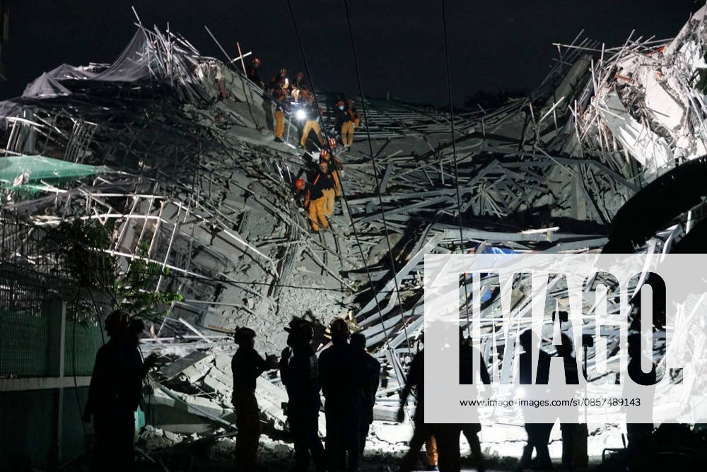 (260525) -- MANILA, May 25, 2026 -- Rescuers search for survivors at the site of a collapsed building in Angeles City, Pampanga province, the Philippines, May 24, 2026. Four people were confirmed dead after a building collapsed before dawn Sunday in Angeles City in northern Philippines Pampanga province, as search and rescue operations continue for 17 missing people, authorities said Monday. ( Handout via Xinhua) (SpotNews) PHILIPPINES-PAMPANGA-ANGELES-BUILDING COLLAPSE BureauxofxFirexProtectionxCentralxLuzon
