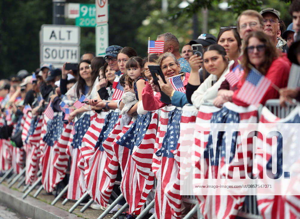 Attendees holding American flags cheer on parade participants during the National Memorial Day Parade in Washington, DC, USA, on May 25, 2026. The parade has been held annually since 2005, marking its 21st anniversary. Washington USA - ZUMAs337 20260525_znp_s337_012