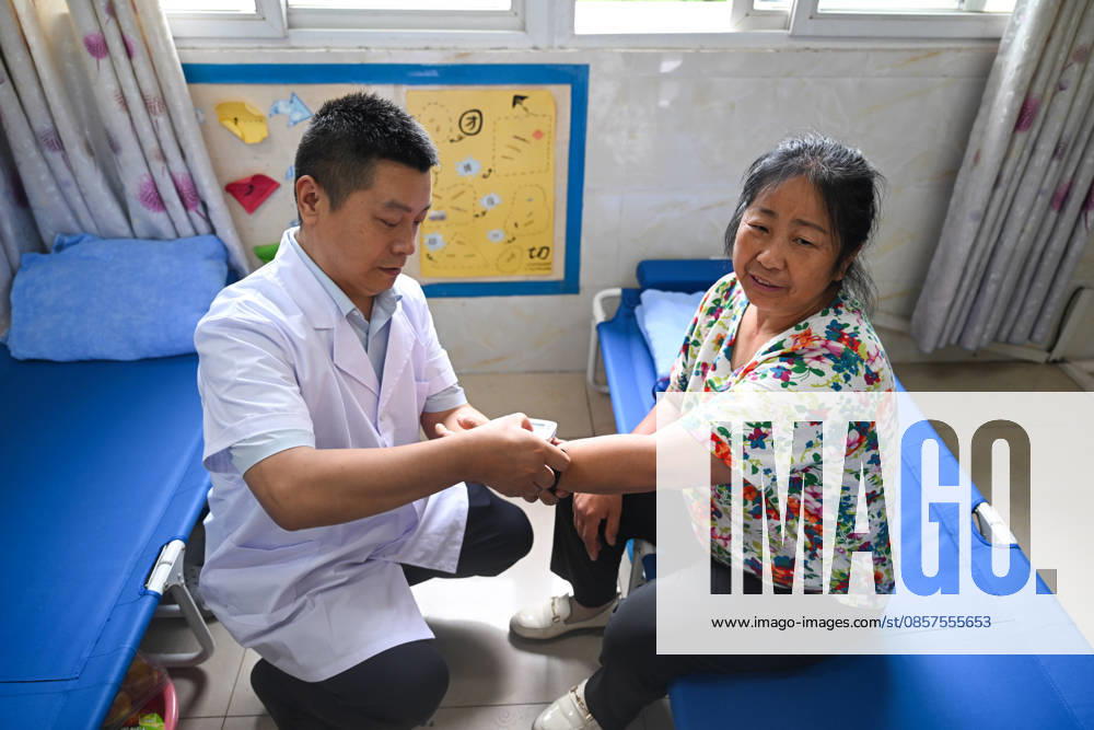 A medical worker checks the health status of a disaster-affected resident at a resettlement site set up in a school after a heavy rainstorm hit Yongchuan District on May 25, 2026 in Chongqing, China. Local authorities have set up 42 centralized shelters accommodating over 2,100 people following flash floods and geological disasters triggered by extreme rainstorms that hit Yongchuan District from the night of May 23 to the early hours of May 24.