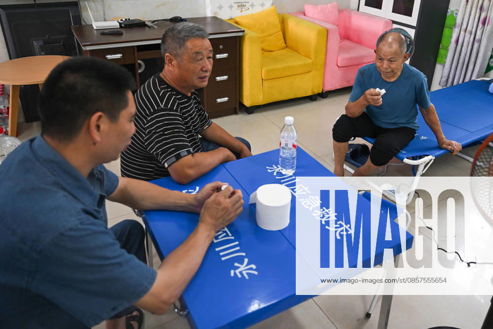 Disaster-affected residents sit and talk at a resettlement site set up in a school after a heavy rainstorm hit Yongchuan District on May 25, 2026 in Chongqing, China. Local authorities have deployed over 1,800 rescue workers to conduct search and rescue operations and hazard inspections after severe storms and flash floods hit the area from the night of May 23 to the early morning of May 24.
