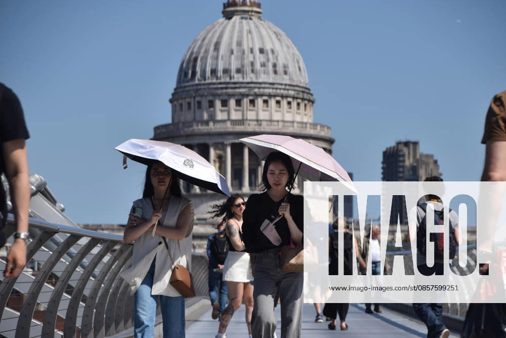 People shelter from the scorching sun under umbrellas on Millennium Bridge with a view of St Paul s Cathedral as temperatures soar in the capital. The UK recorded its hottest ever day in May yesterday. London United Kingdom - ZUMAv130 20260526_zip_v130_002