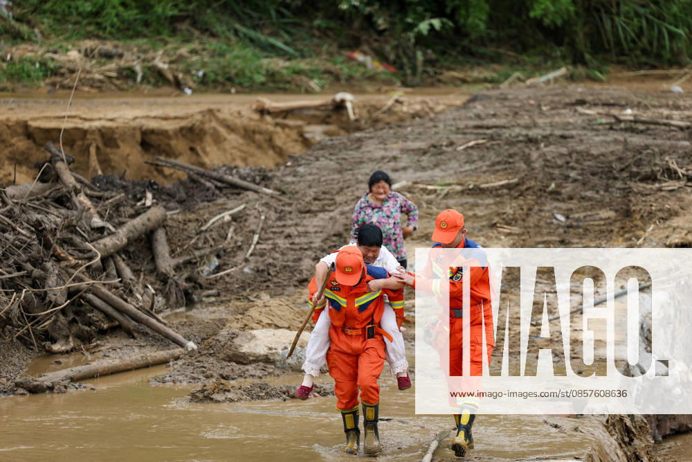(260526) -- CHONGQING, May 26, 2026 -- Rescuers assist a villager passing through a waterlogged section at Yongchuan District of southwest China s Chongqing Municipality, May 26, 2026. From Saturday night to early Sunday morning, a sudden and extreme catastrophic rainstorm struck Yongchuan, triggering flash floods and geological disasters in multiple areas of this district. After the disaster occurred, the local authorities immediately activated the emergency response mechanism, coordinated rescue forces from all sides and made every effort to carry out rescue operations and infrastructure restoration. Rescue and response efforts are still underway. ) CHINA-CHONGQING-FLOOD-RESCUE (CN) HuangxWei